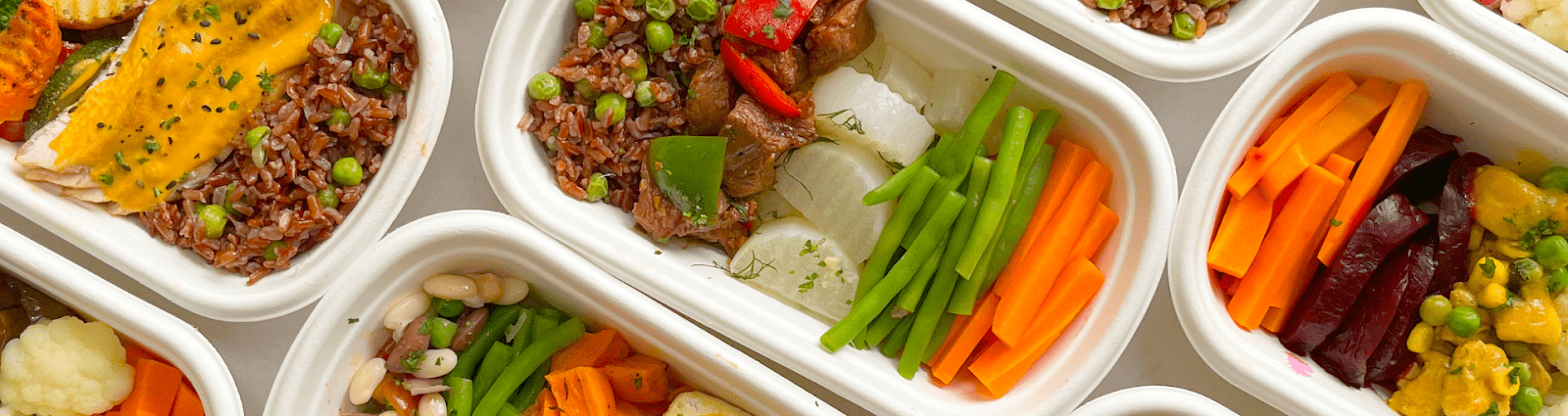 Meal-Prep Containers Filled With Colorful High Protein Bowls, Sauces, And Grains.